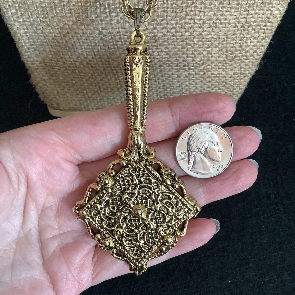 Vintage gold tone hand mirror pendant necklace.